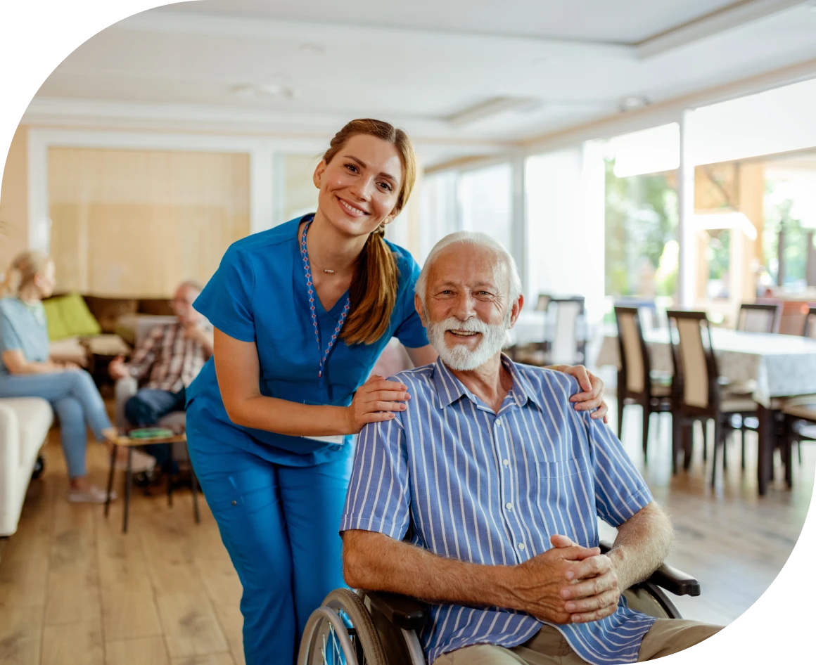 Smiling nurse with senior in care facility